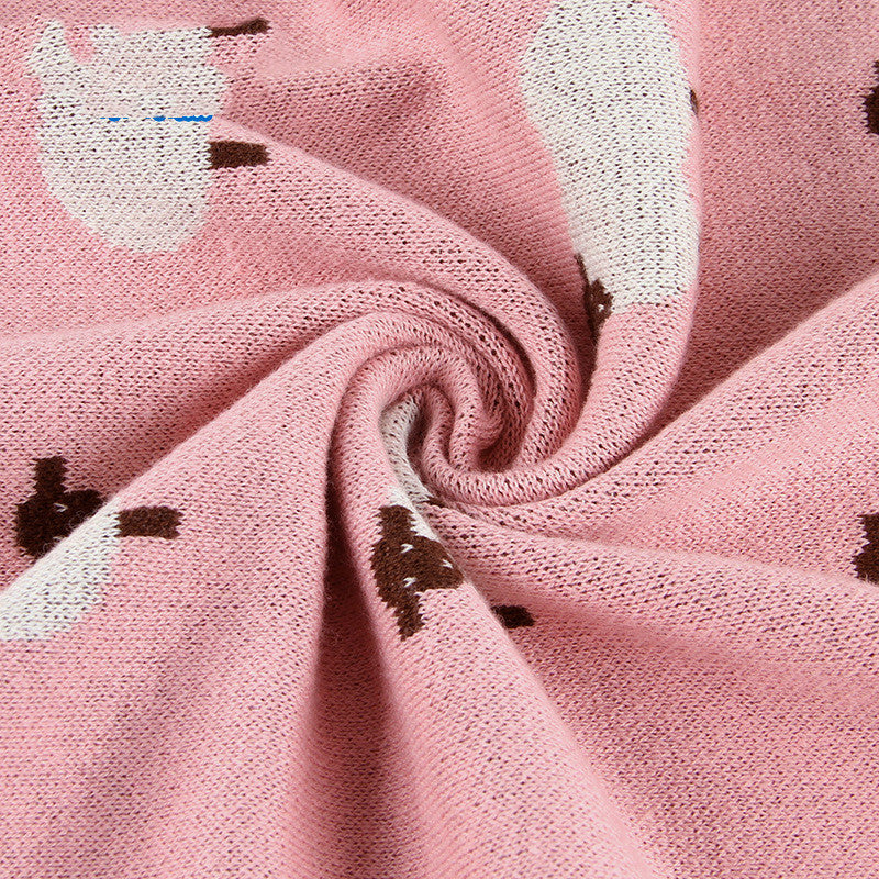 Soft pink knitted baby blanket featuring white sheep pattern, cozy and breathable for infants