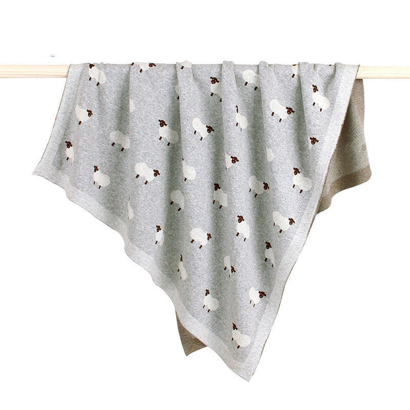 Soft grey knitted baby blanket featuring white sheep pattern, cozy and breathable for infants