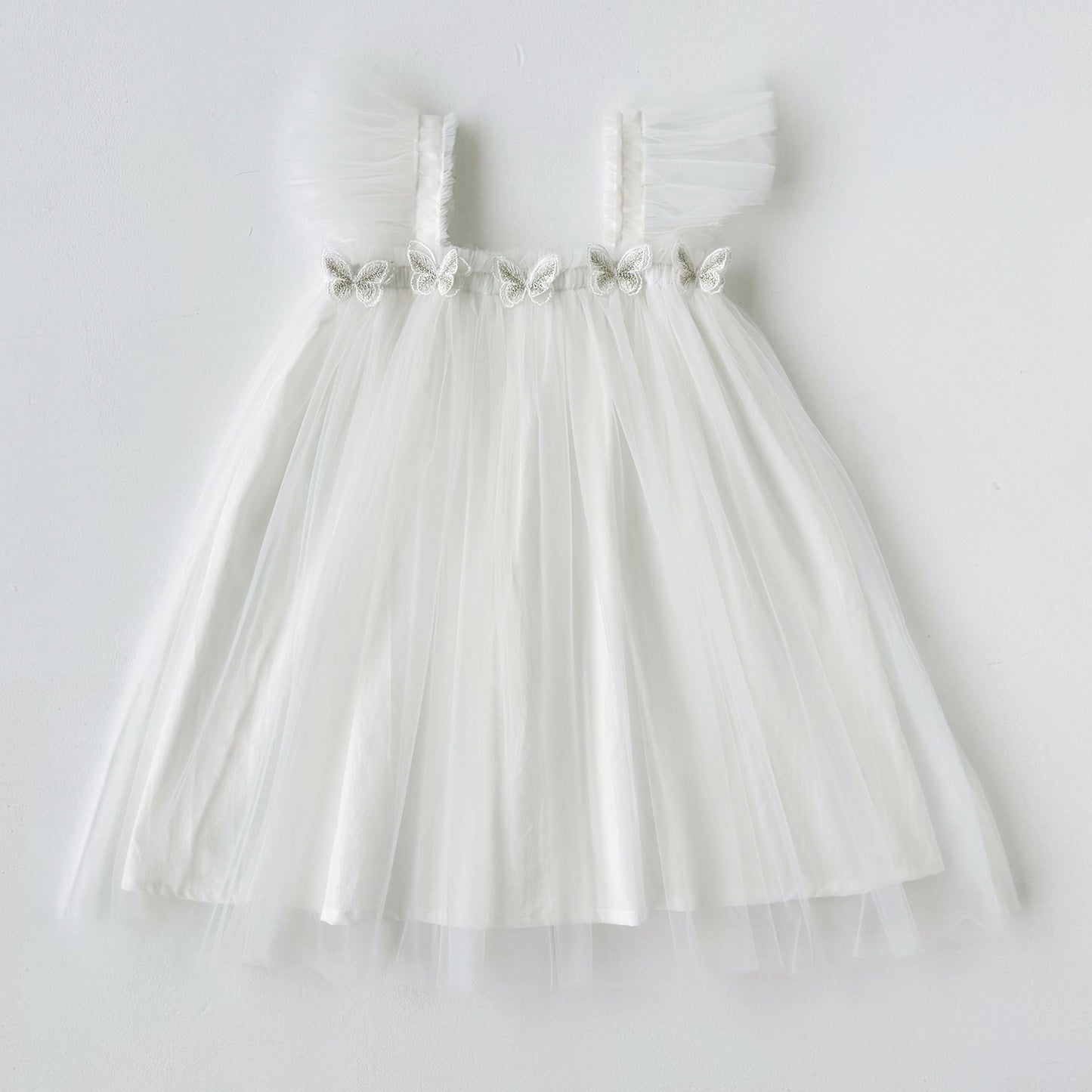White tulle dress with a belt on a white background