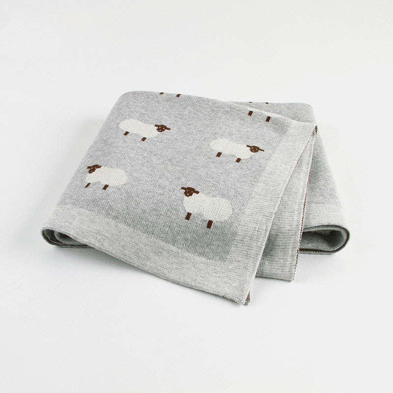 Soft grey knitted baby blanket featuring white sheep pattern, cozy and breathable for infants