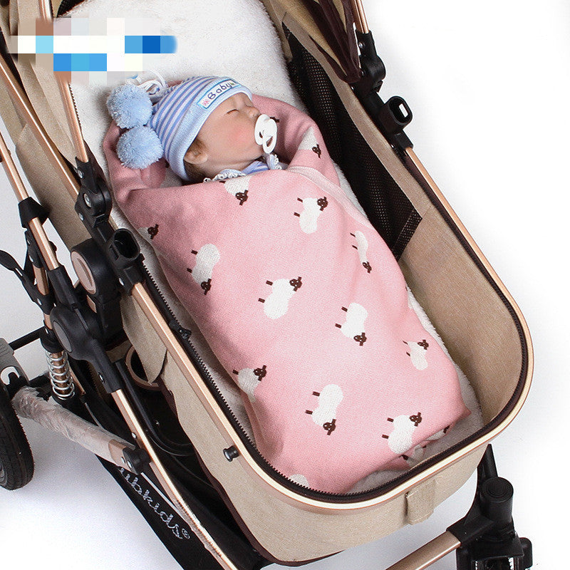 Soft pink knitted baby blanket featuring white sheep pattern, cozy and breathable for infants