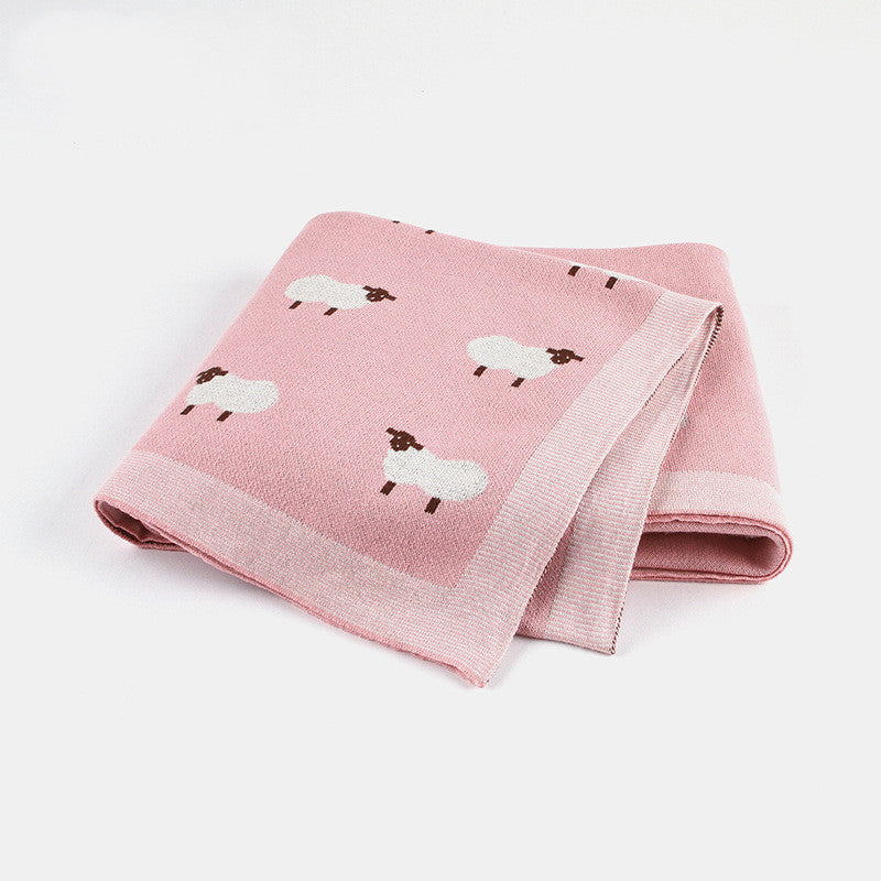 Soft pink knitted baby blanket featuring white sheep pattern, cozy and breathable for infants