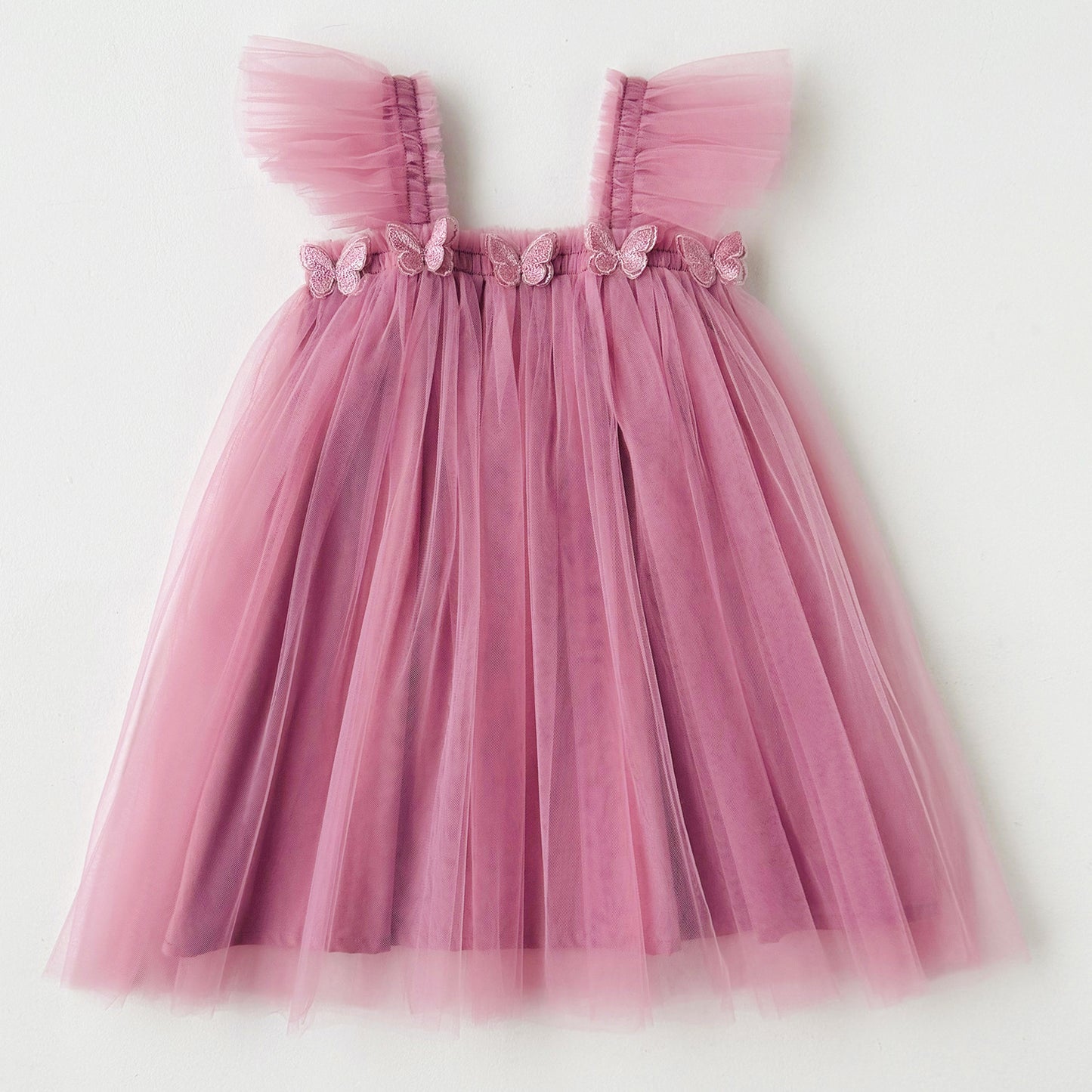 Pink tulle dress with floral details on a white background