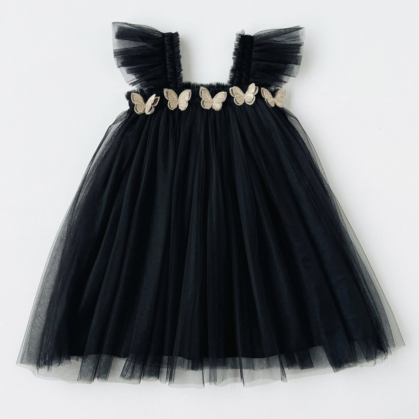 Black tulle dress with butterfly embellishments on a white background